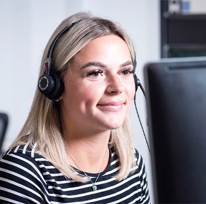 Colleague smiling whilst working at their desk